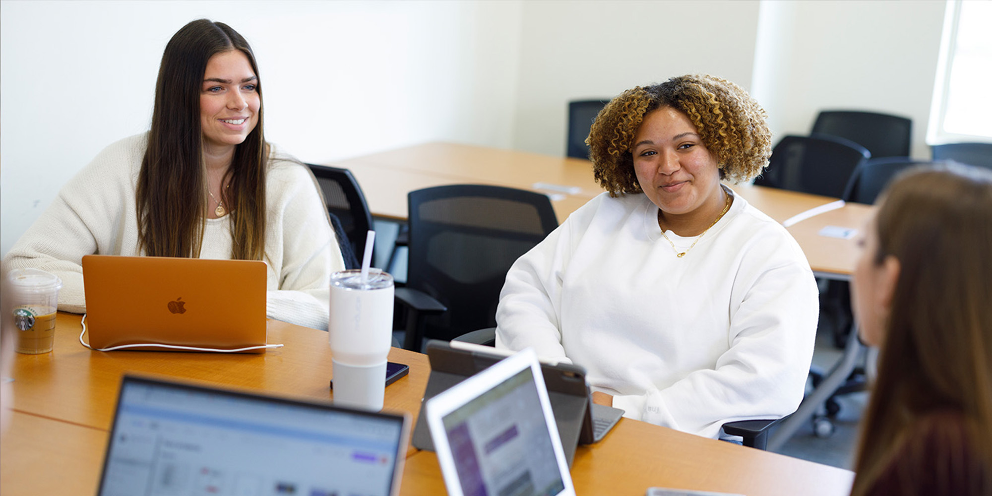 Three Female Students In Communication Discussion