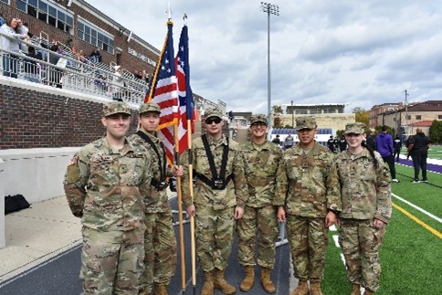 Color guard presents at a Capital football game