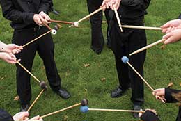 members holding drum sticks