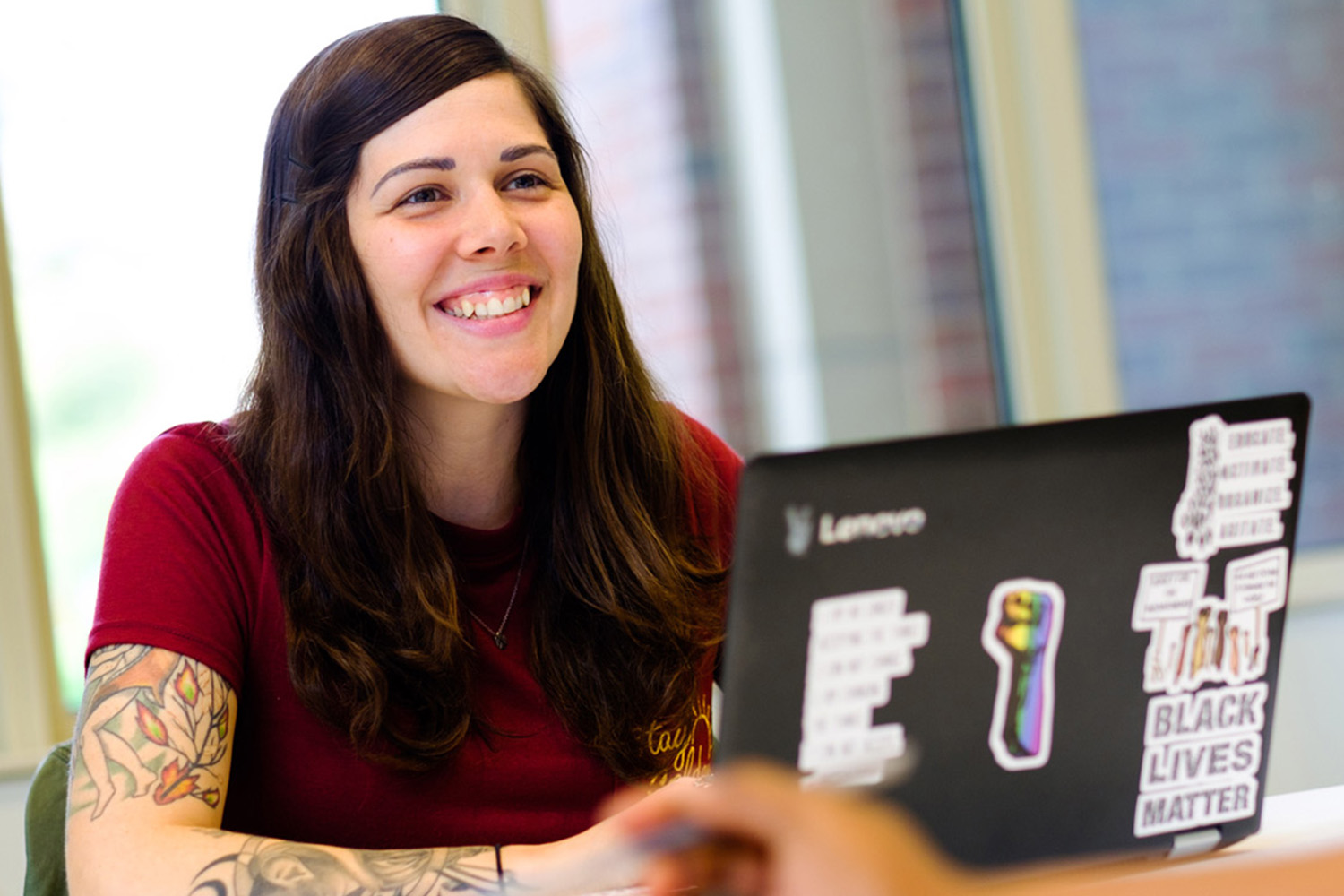 Female With Tatoos Smiling In Class