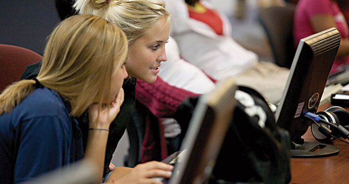 Students looking at a computer